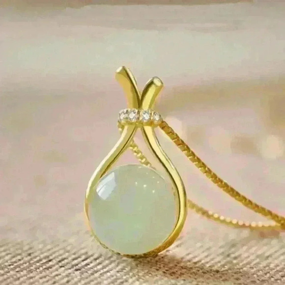 Jade Stone encased in a sleek gold necklace, accented with a sparkling c… - Picture 2 of 4